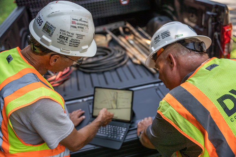 construction crew working on a tablet